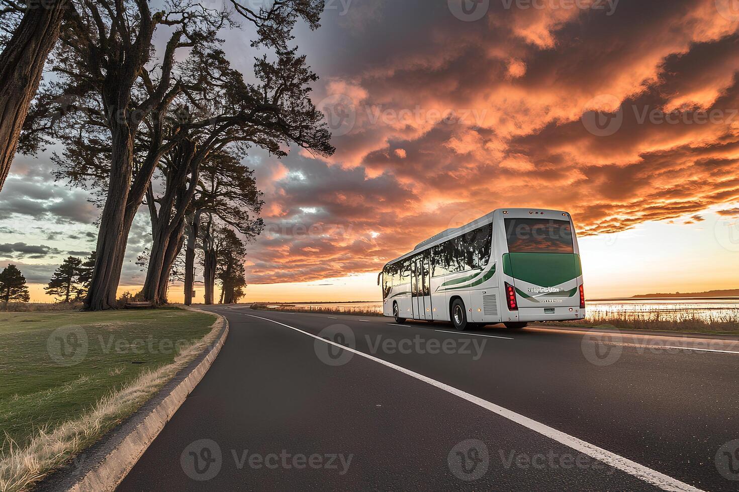 A tourist bus driving on the highway at sunset, surrounded by a stunning golden sky and scenic landscape photo