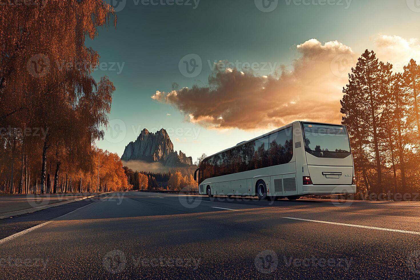 A bus traveling along a winding mountain road at sunset, surrounded by breathtaking scenic views photo