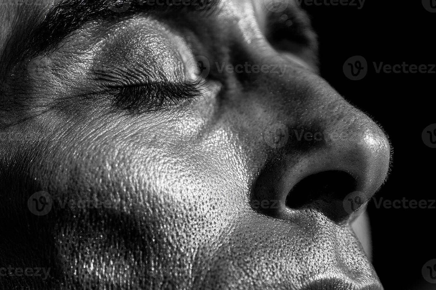 A closeup portrait of a mans face, decorated with striking black and white paint, creating a bold and artistic visual effect. photo