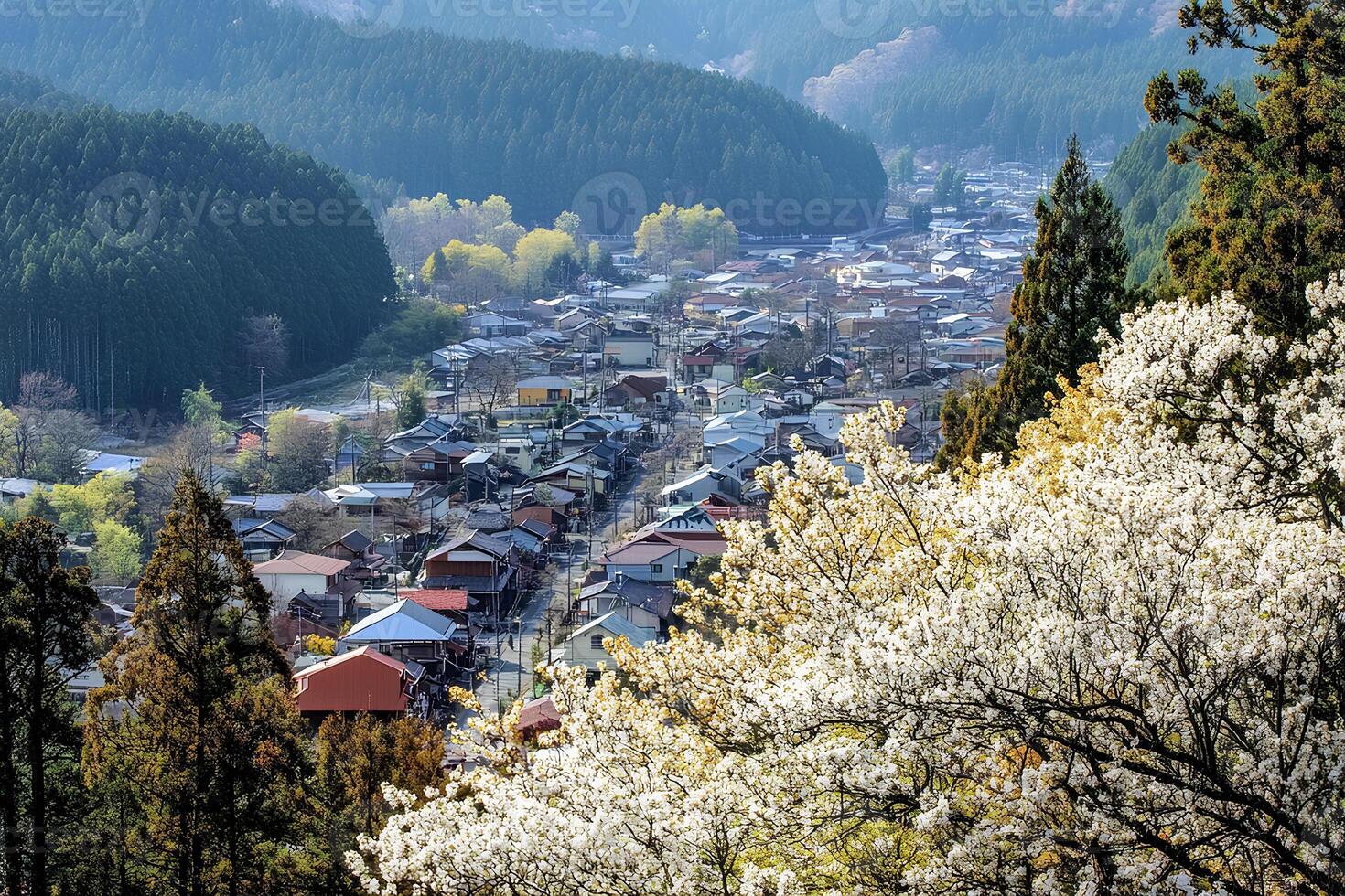 A picturesque view of the historic village of Shirakawa-go in Japan, known for its traditional gassho-zukuri farmhouses, surrounded by lush greenery and stunning mountainous landscapes. photo