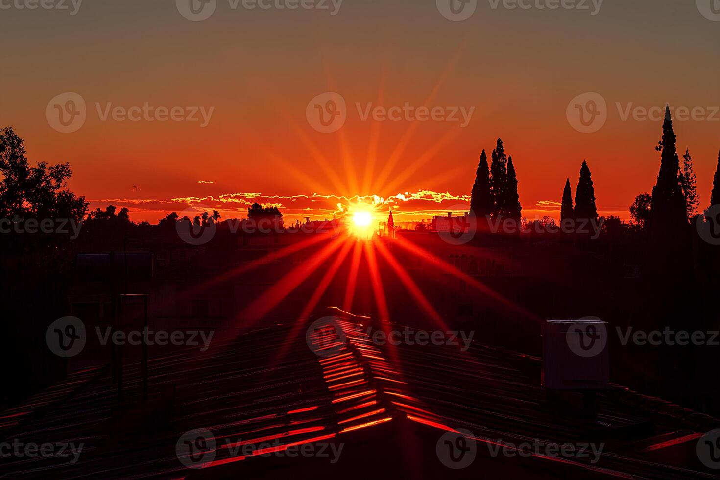 A breathtaking sunset casting warm golden light over the rooftops of an old town, with the rays of the setting sun creating a serene and magical atmosphere photo