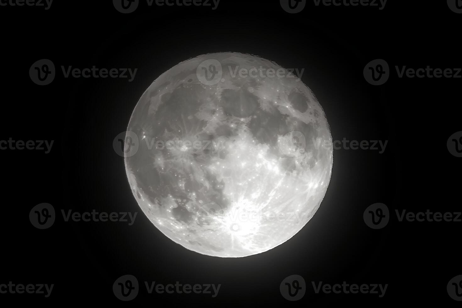 A black and white image of the full moon shining brightly in the dark night sky, creating a dramatic and peaceful atmosphere photo