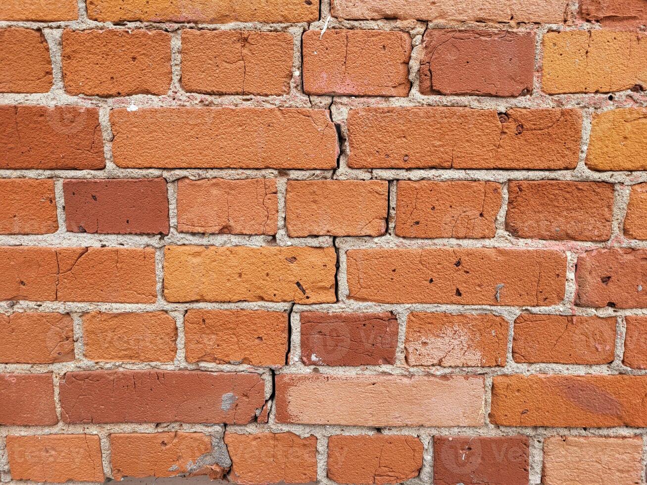 The background of the wall is made of red brick photo