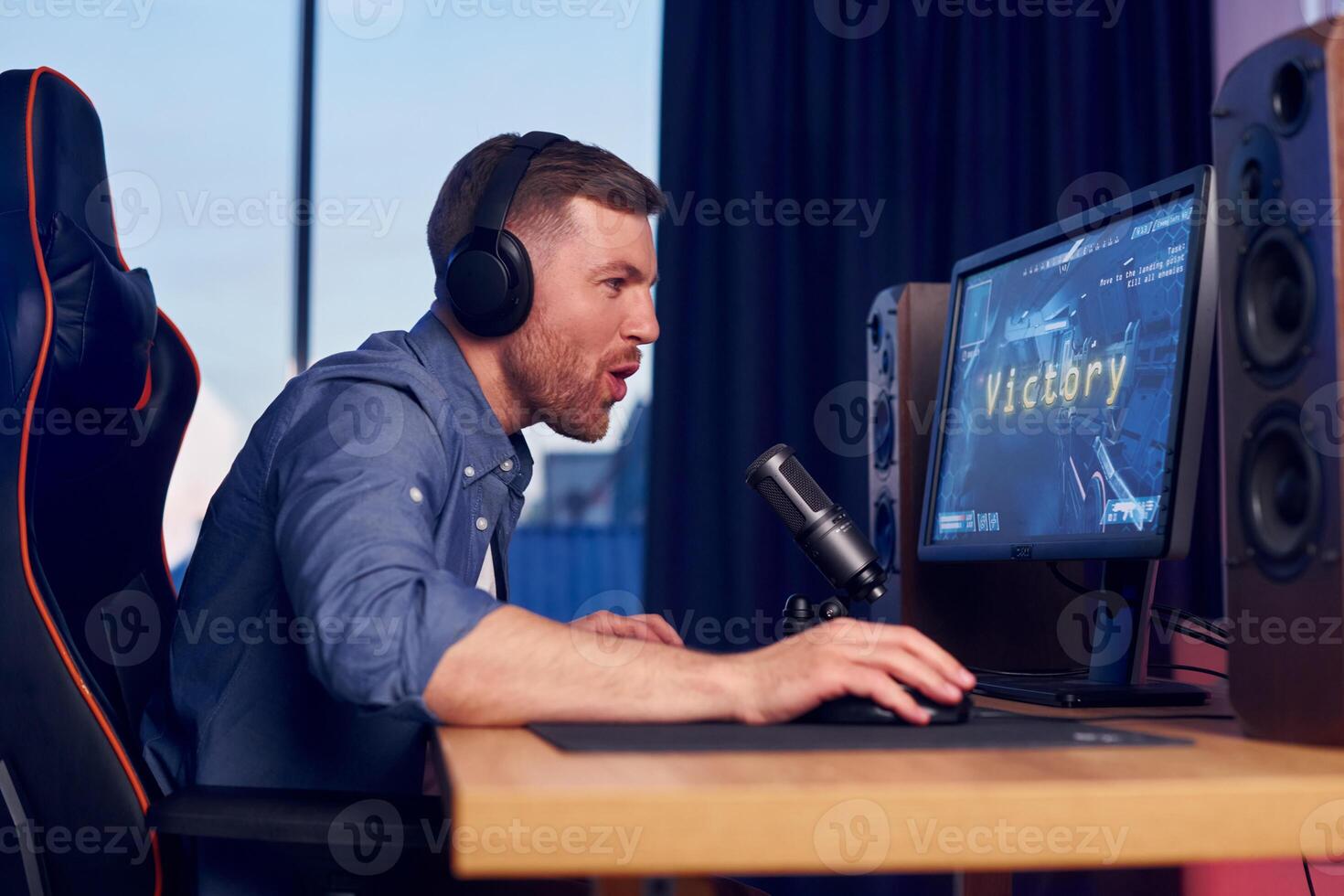 A man wearing headphones is playing games photo