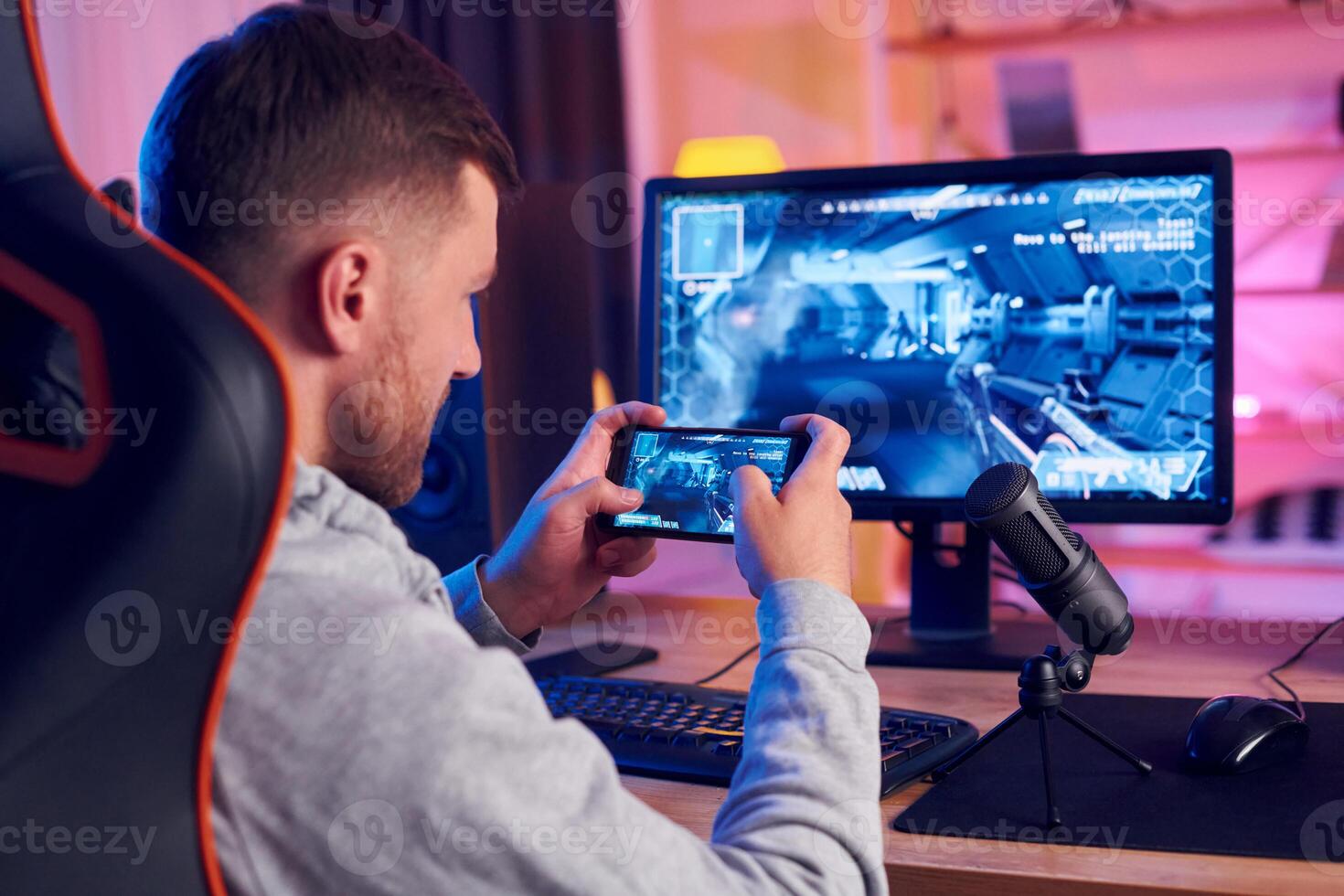 A man is playing a game on his phone photo