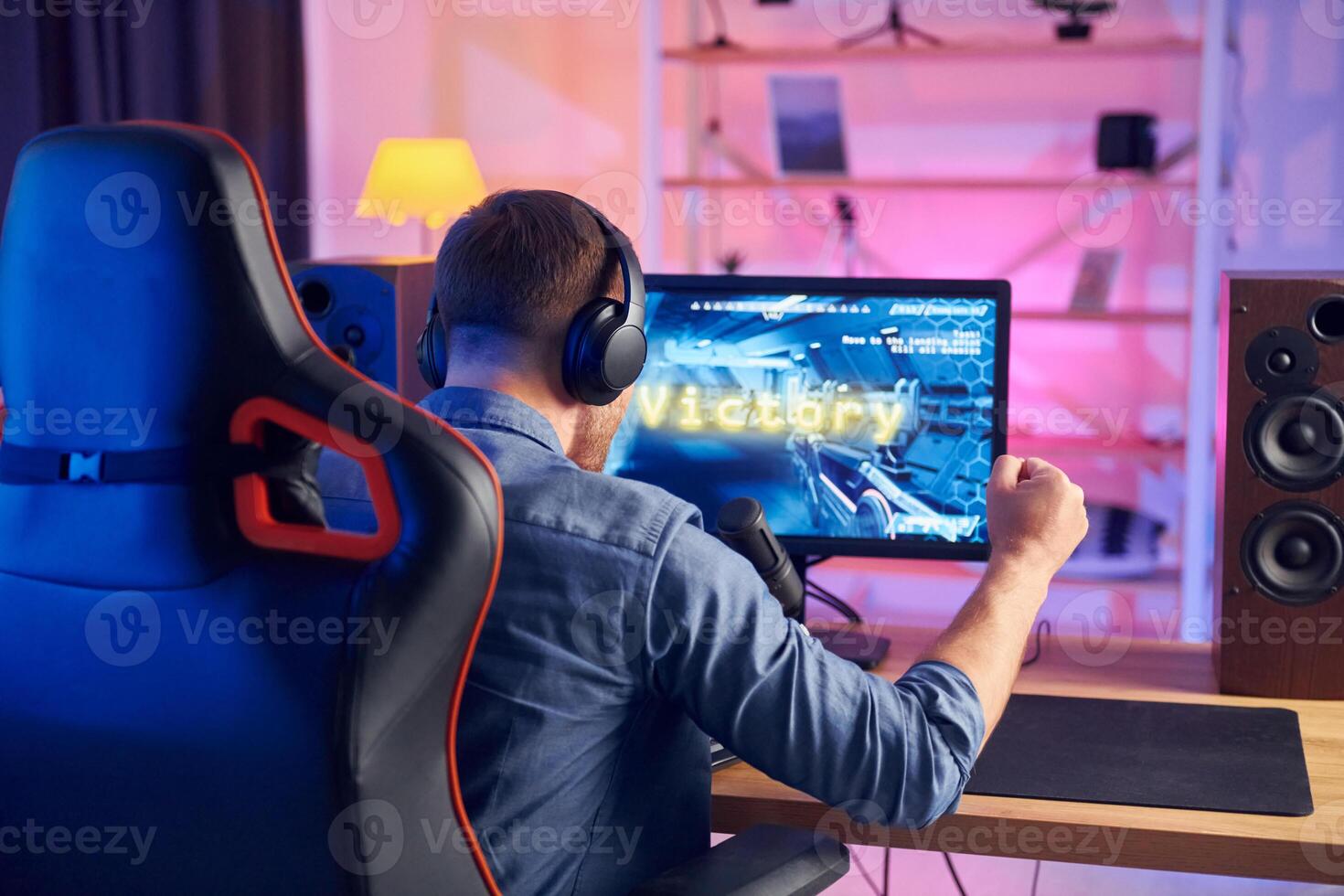 A man is playing games on a computer photo