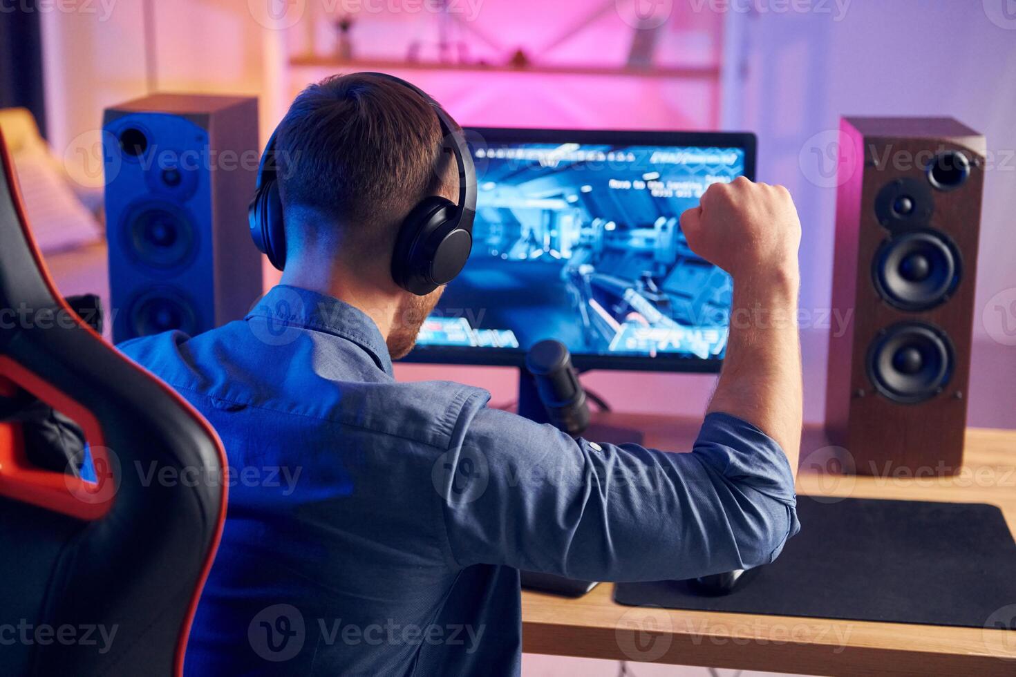 A man is playing games on a computer photo
