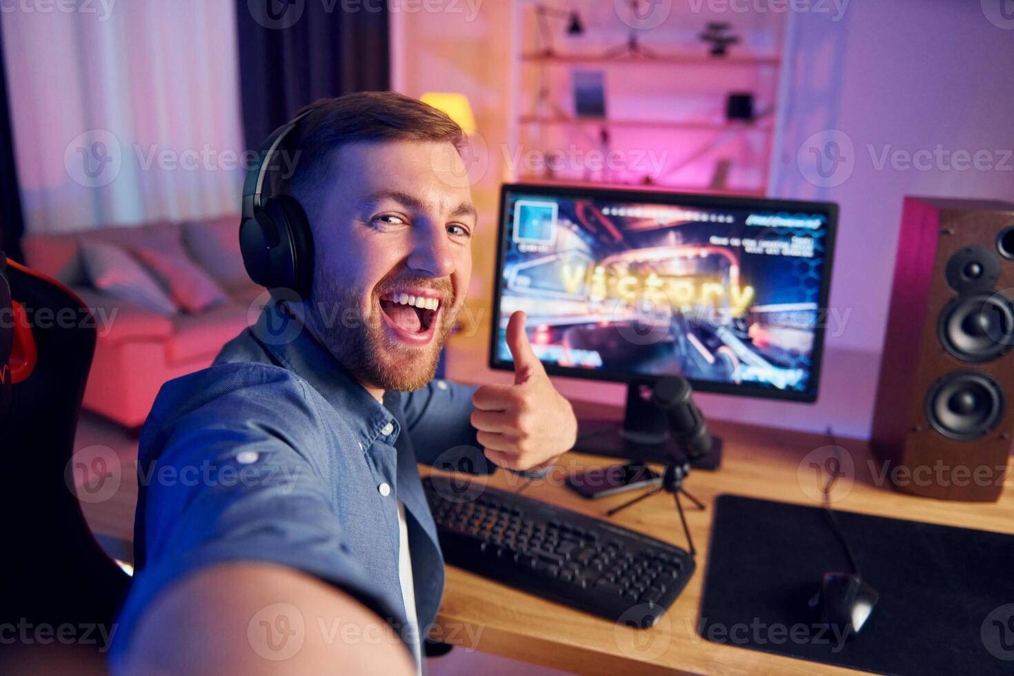 A man is playing a game on his computer photo