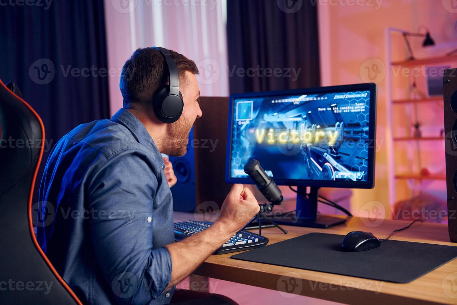 A man is playing games on a computer photo