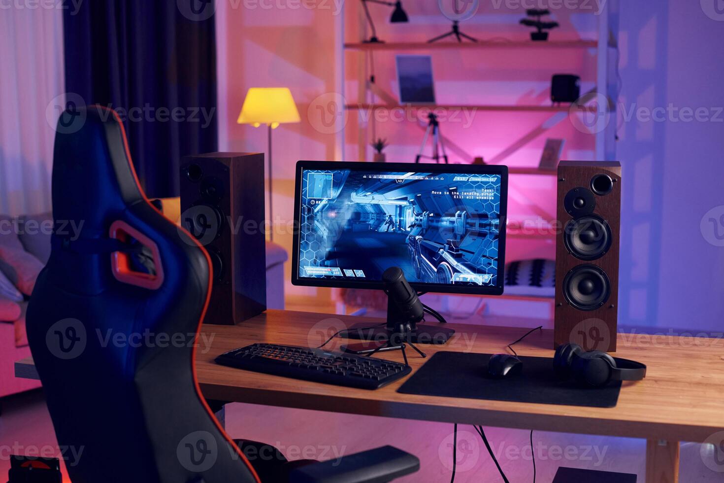 A gaming desk with a computer and speakers photo
