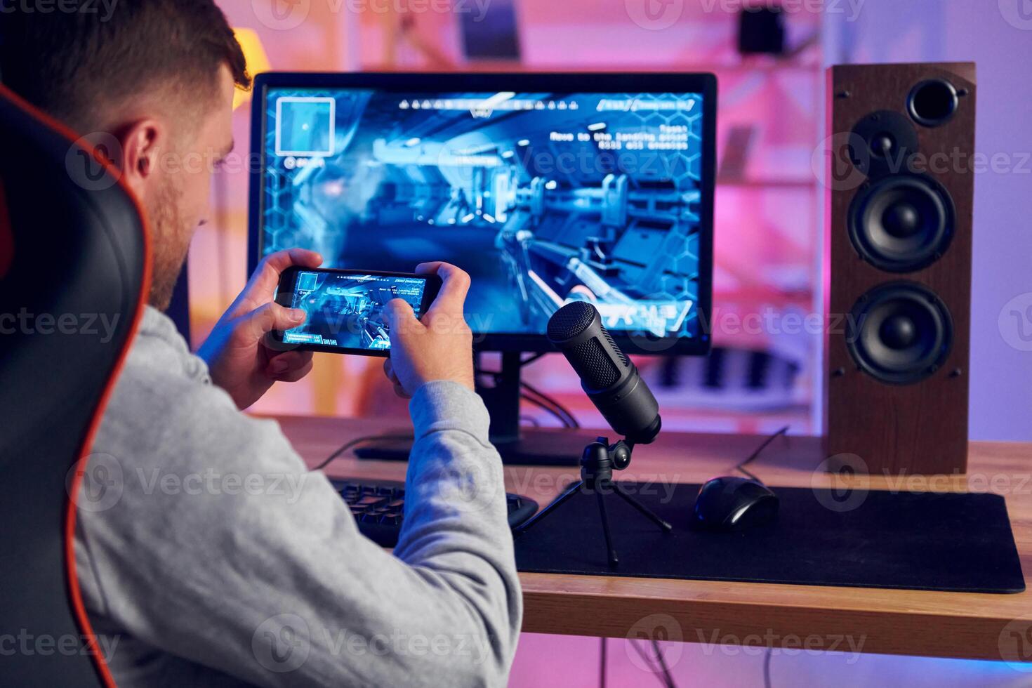 A man is playing a game on his computer photo