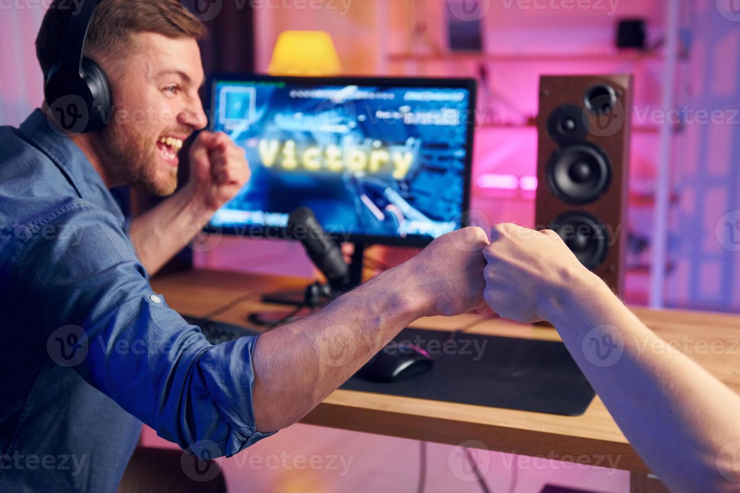 Two men playing games on a computer photo