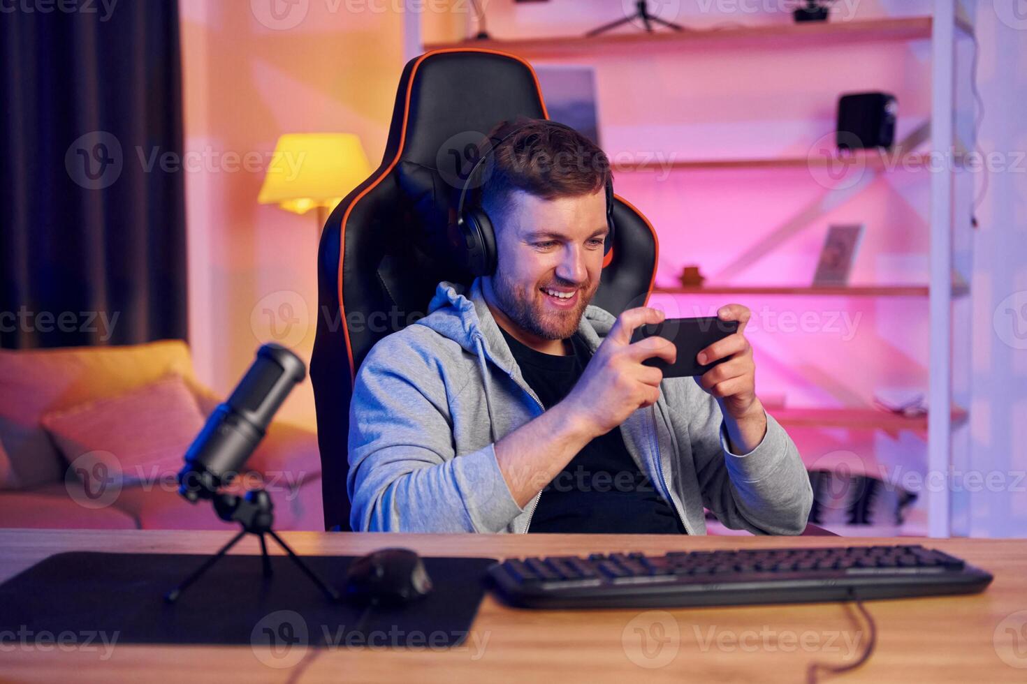 A man in headphones is playing a game photo