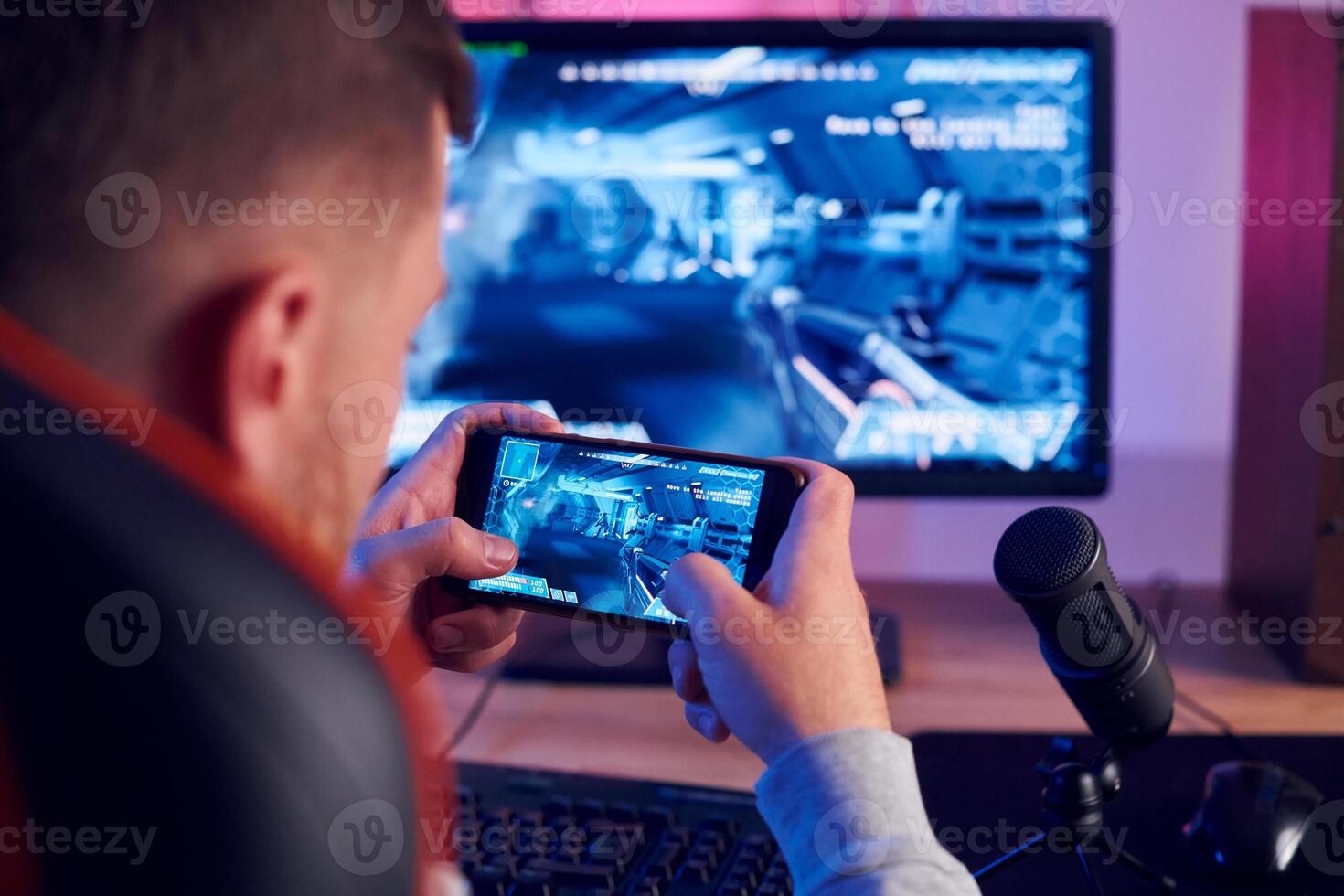 A man is playing a game on his phone photo