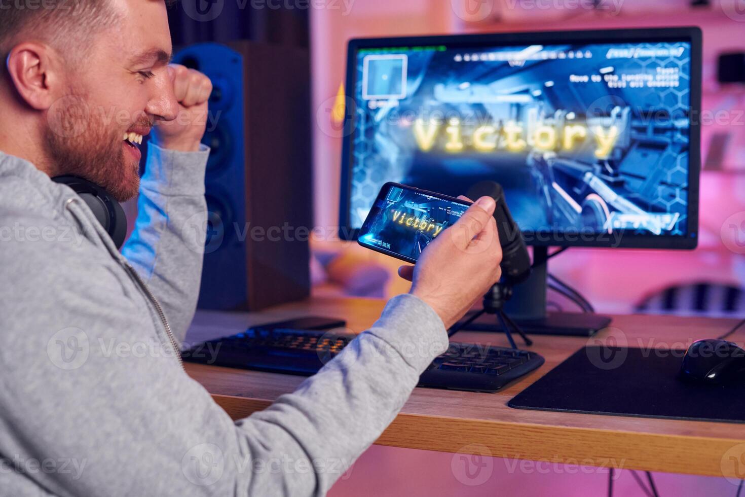 A man is playing a game on his computer photo