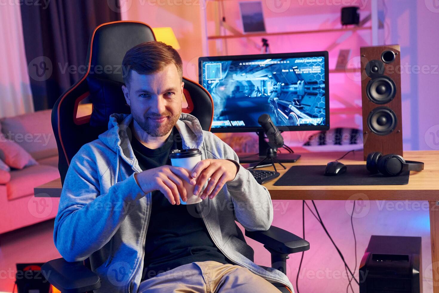 A man sitting in a chair with a cup of coffee photo