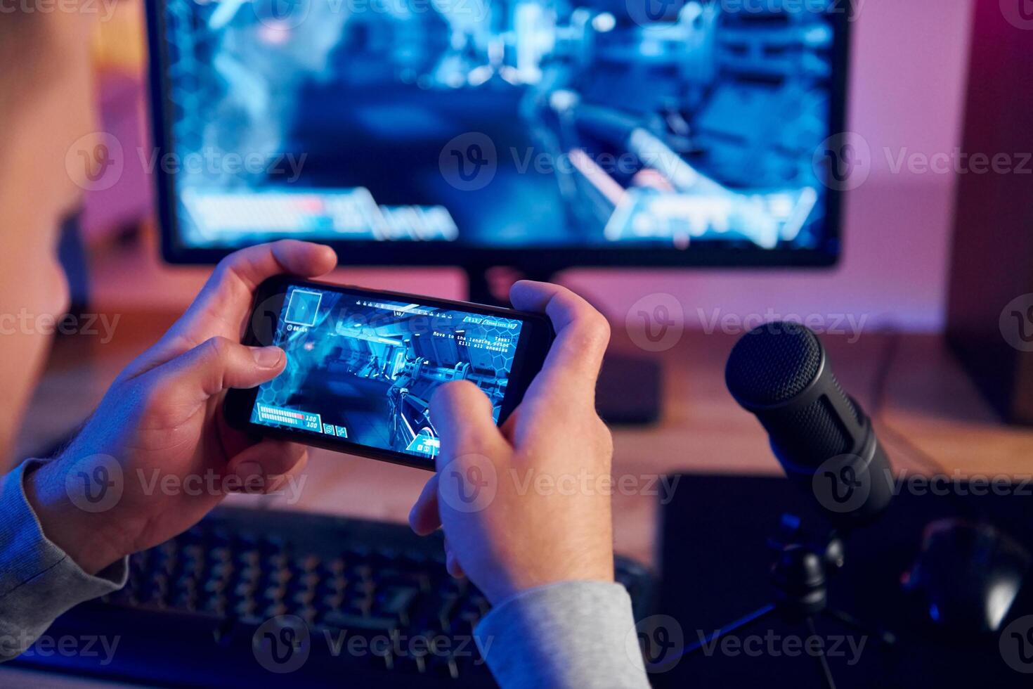 A man is playing a game on his phone photo