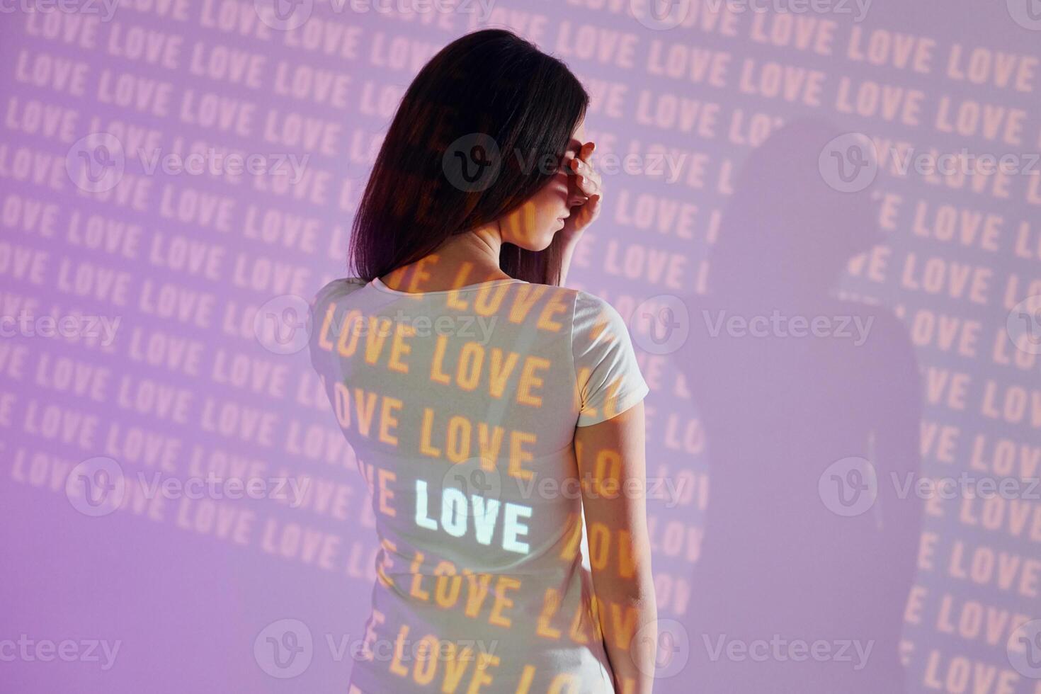 A woman wearing a t - shirt with the word love on it photo