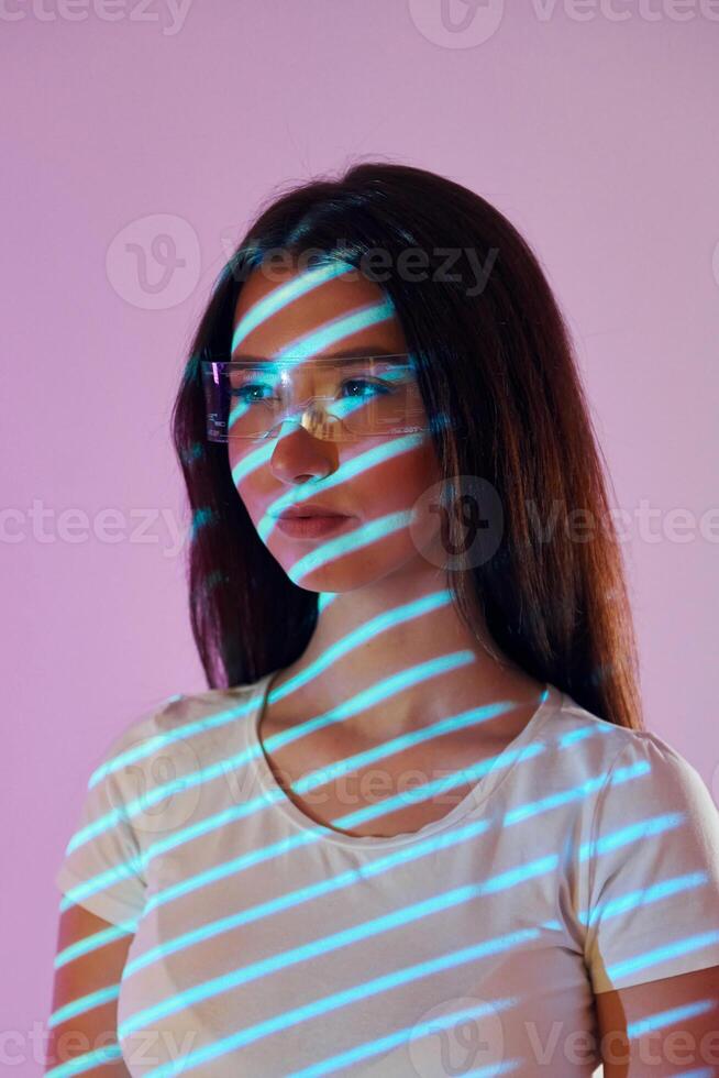 A woman with glasses and a striped background photo