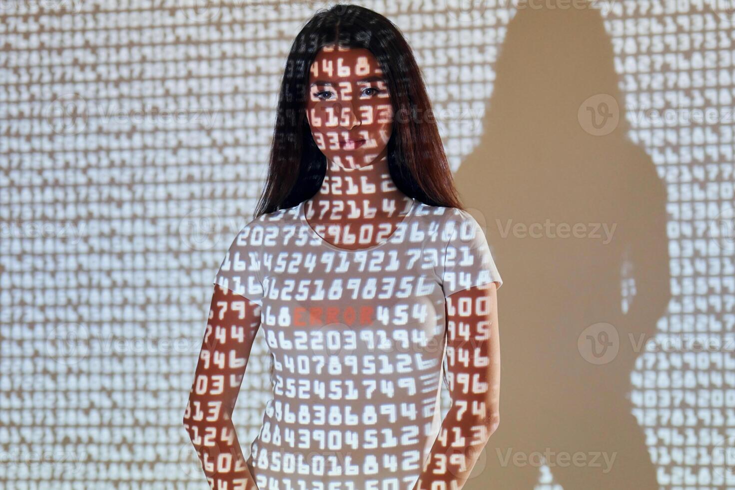 A woman standing in front of a wall with numbers on it. photo