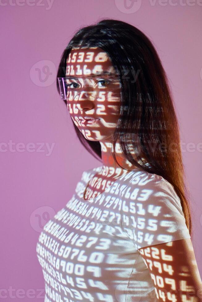 A woman with glasses and a white shirt is reflected in a computer screen photo
