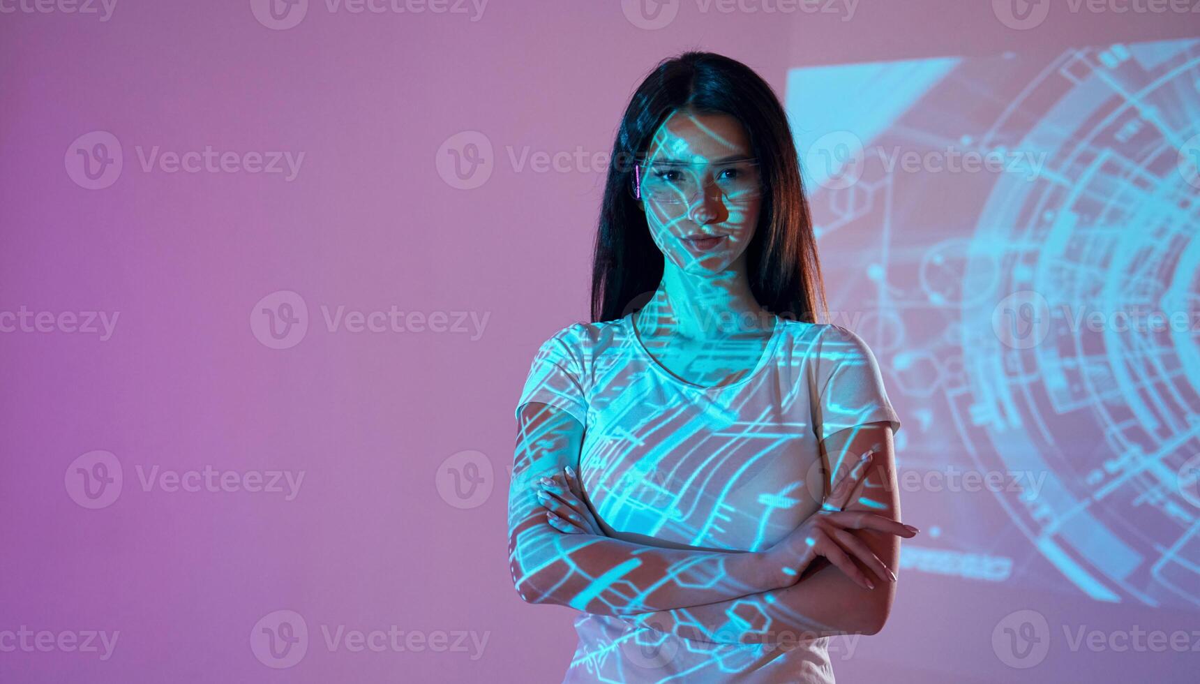 A woman standing in front of a projection screen photo