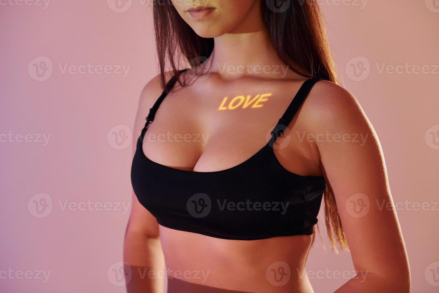 A woman in a black bra top with the word love written on it photo