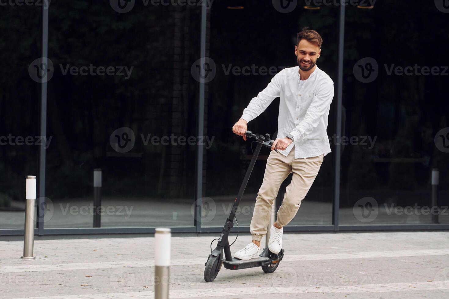 A man riding an electric scooter photo