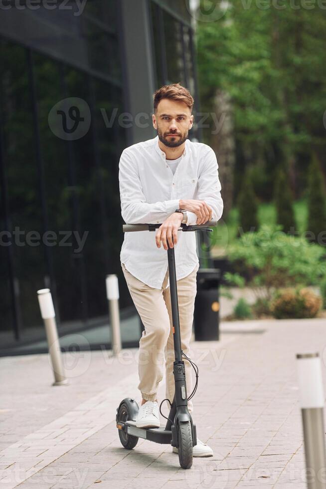 A man is riding an electric scooter photo