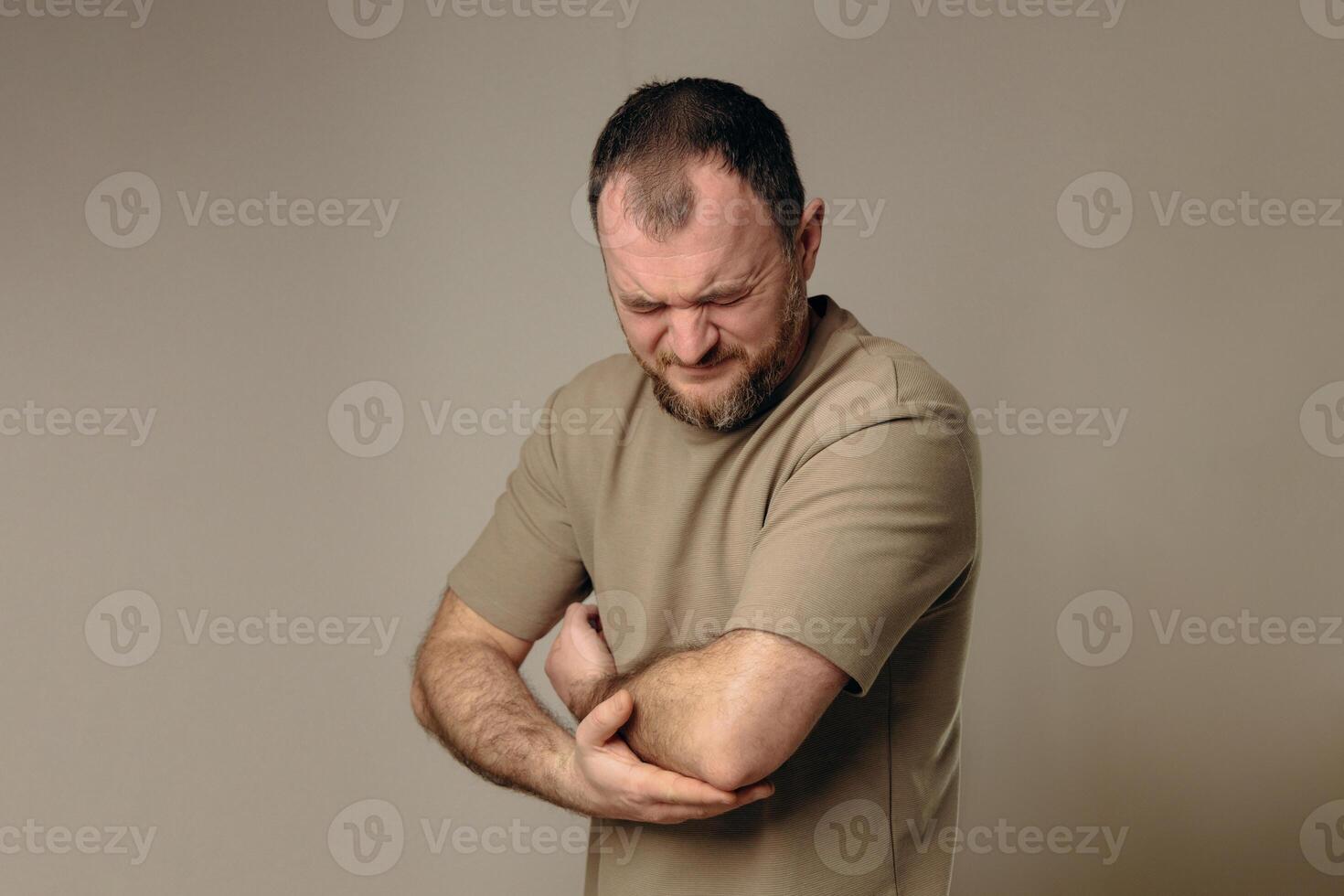 A man experiences problems in the elbow after intense physical exercise, long training or professional activities. performing a warm-up and recovery after physical exercise. photo