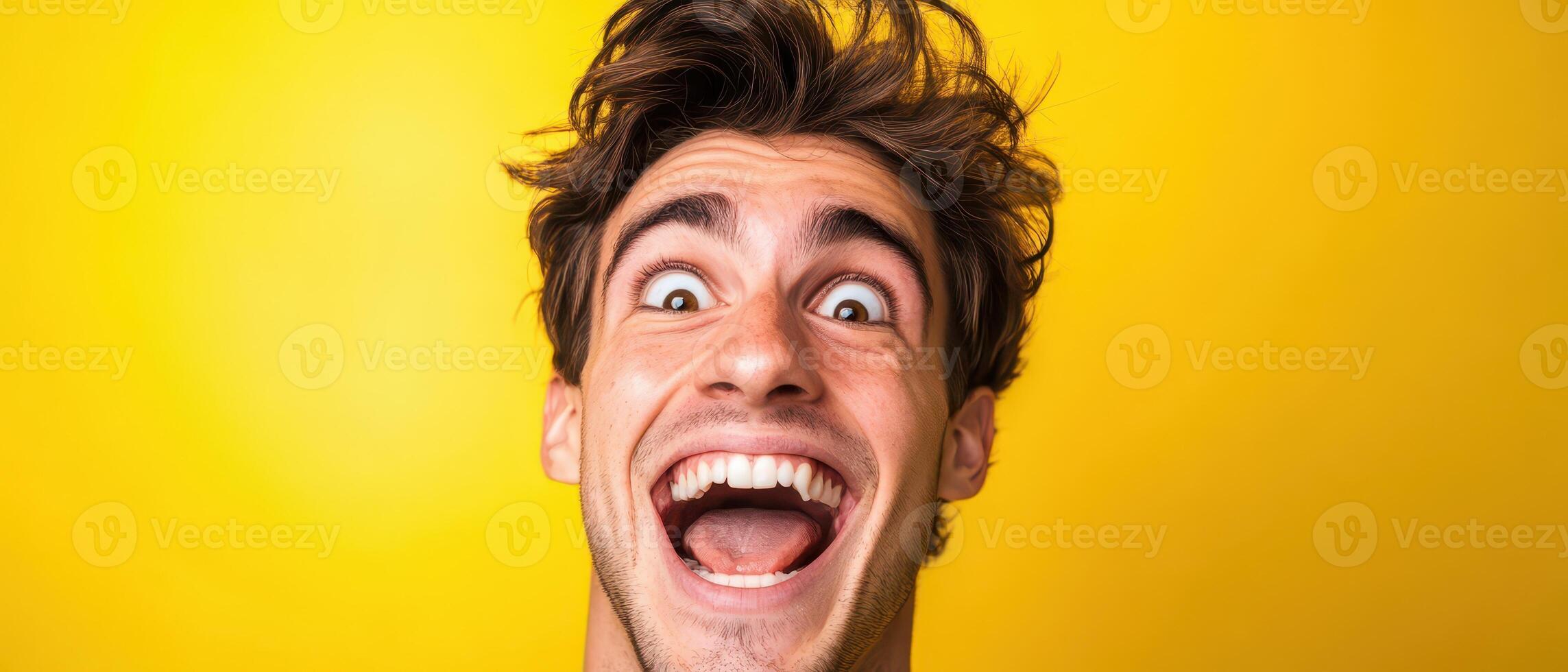 A man is making a funny face with his mouth open photo