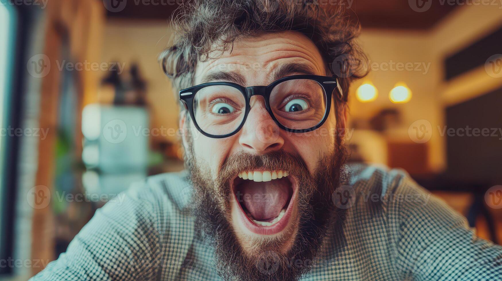 A man with glasses and a beard is making a funny face photo