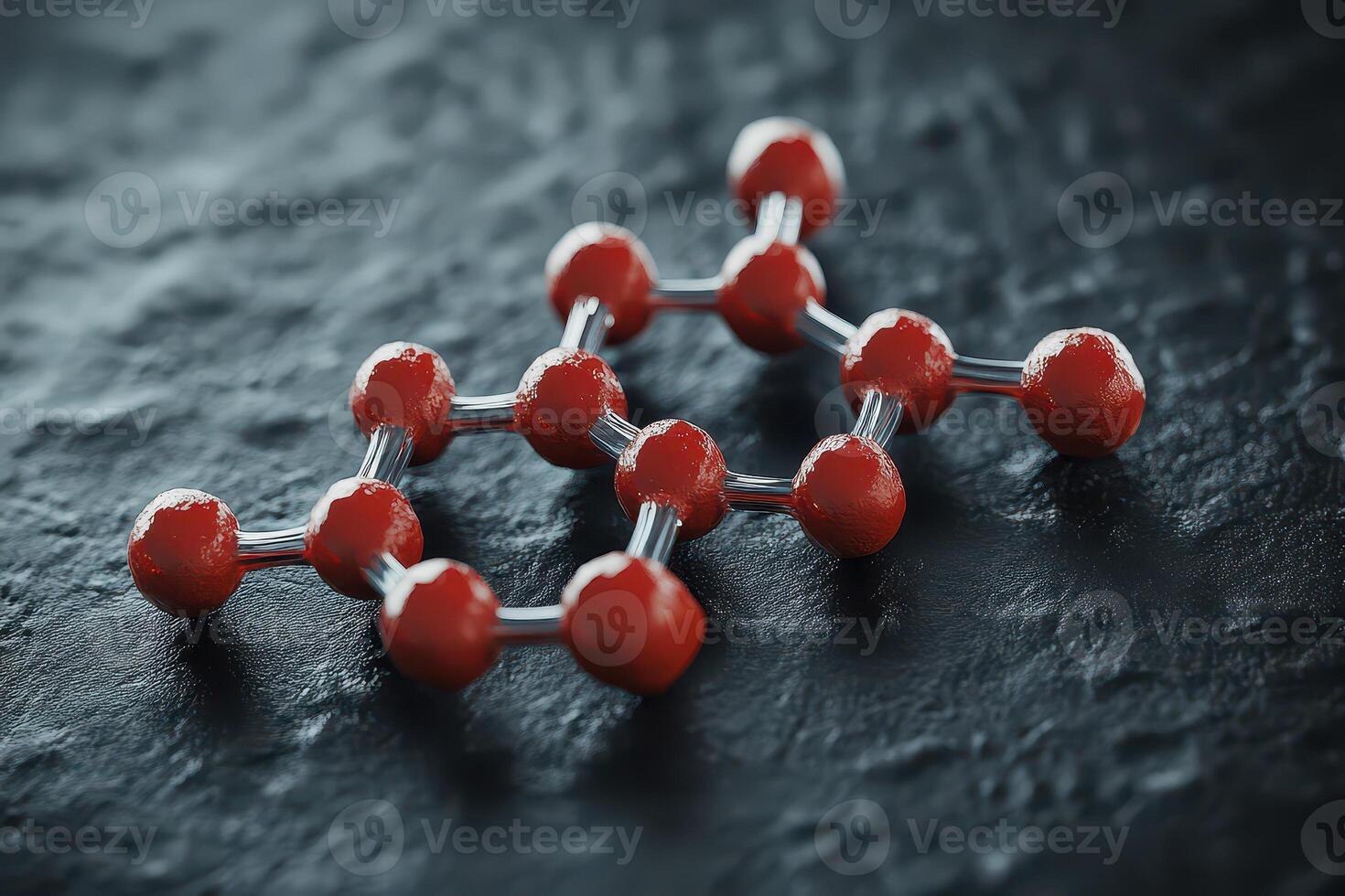 A red molecule on a black surface photo