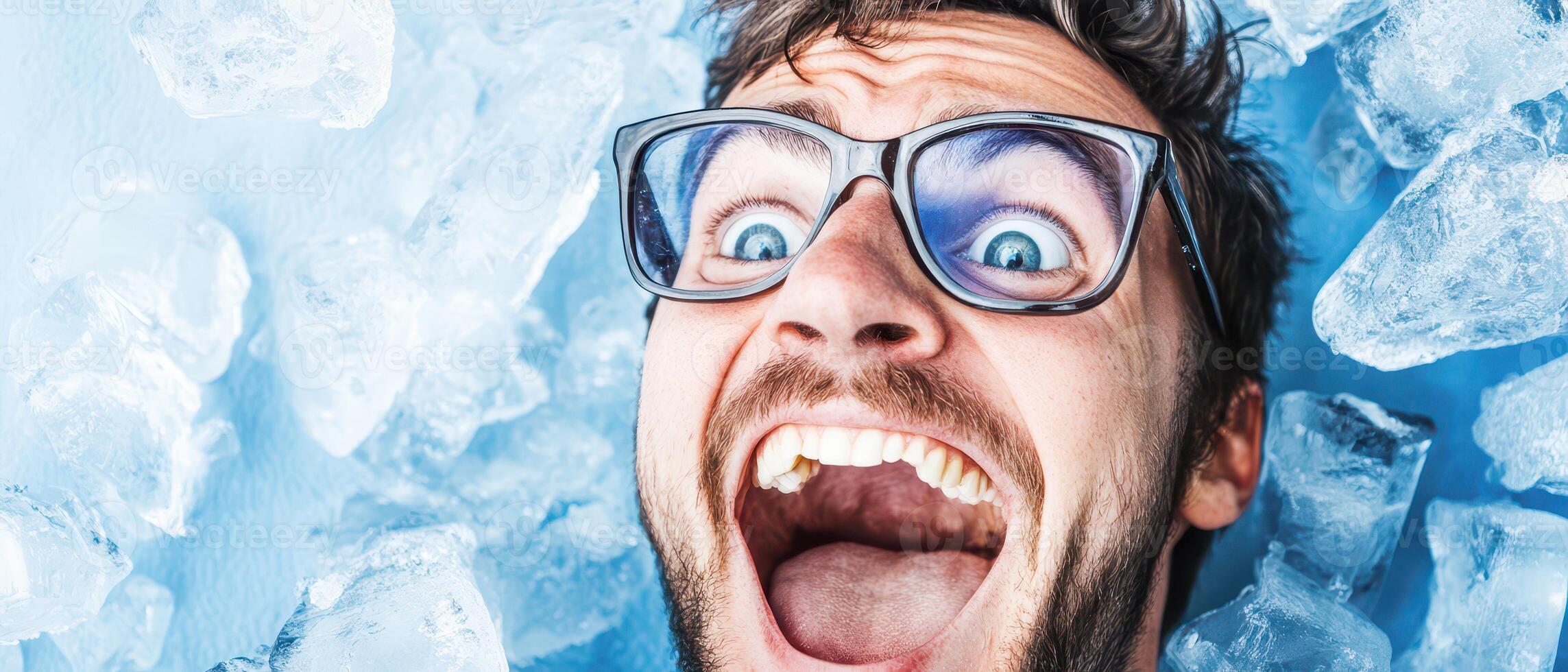 A man with glasses and a mouth open in ice photo