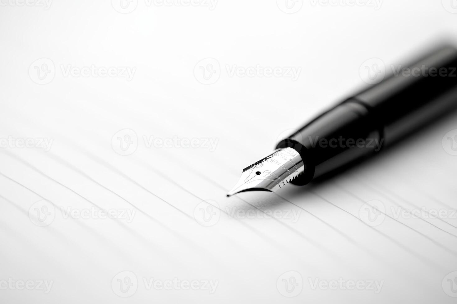 Close-up of a fountain pen poised above blank paper, ready for writing in a creative workspace photo