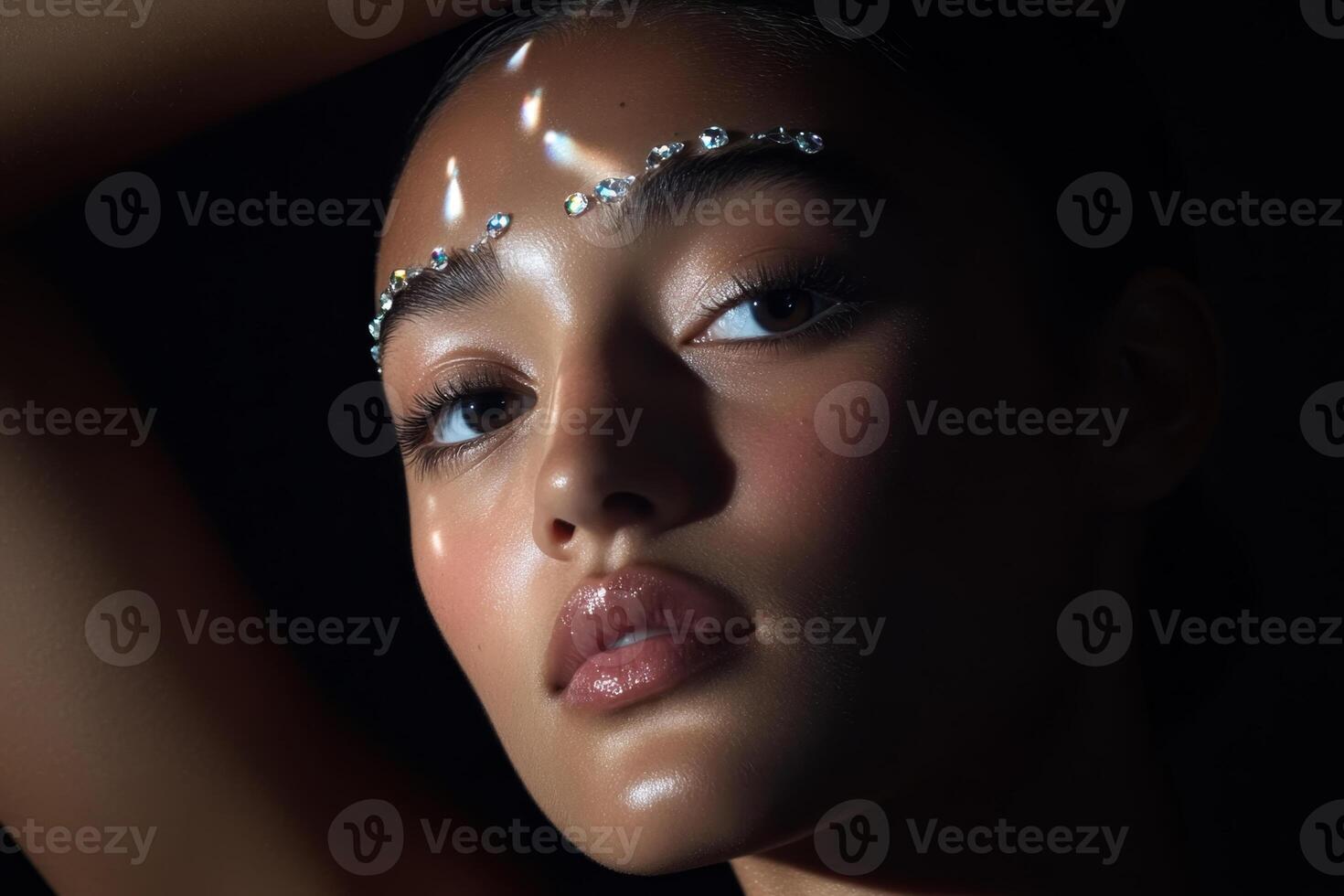 Stunning close-up of a model with glamorous makeup in dramatic lighting during a fashion shoot photo