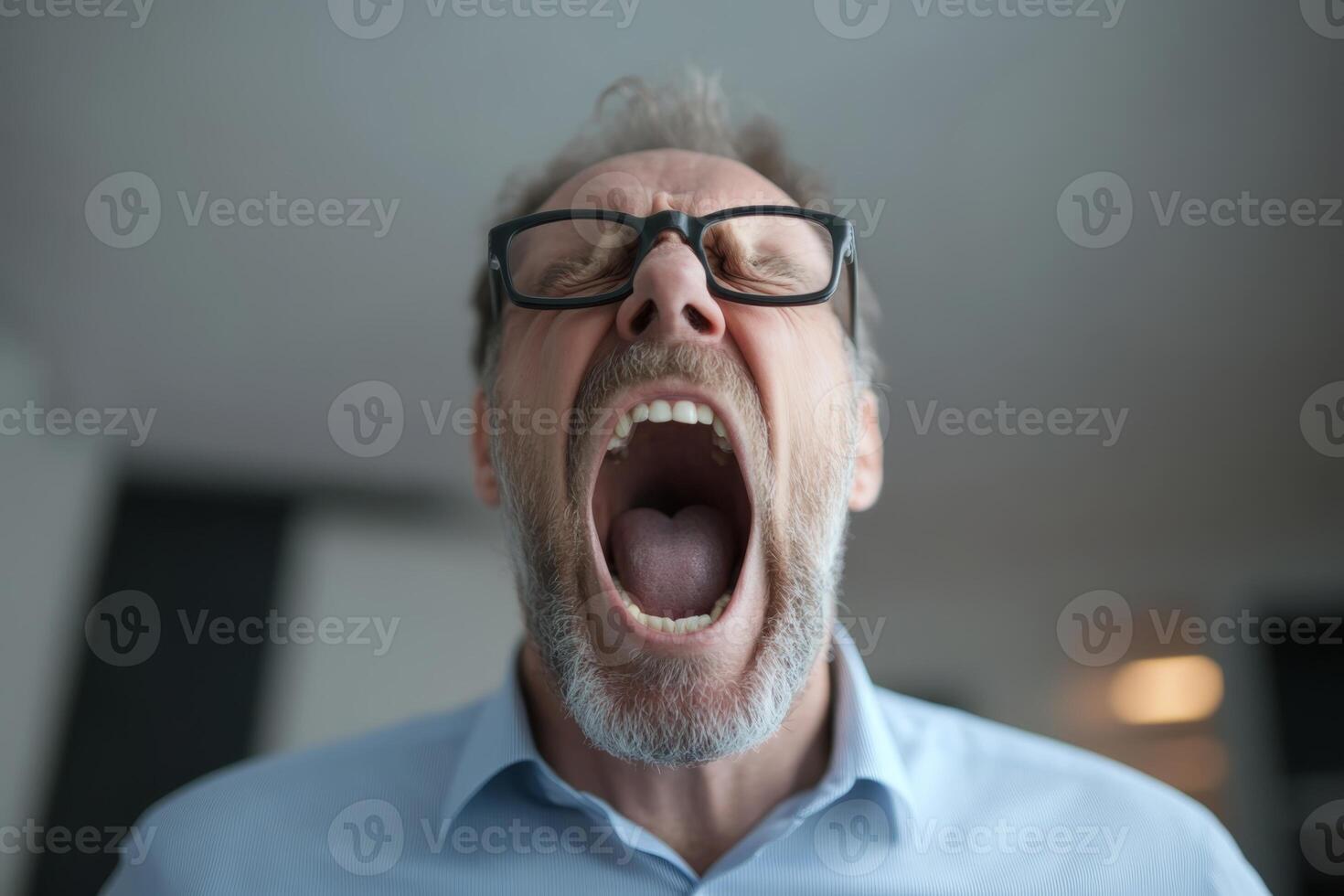 Man expressing frustration in a modern office environment during the day photo