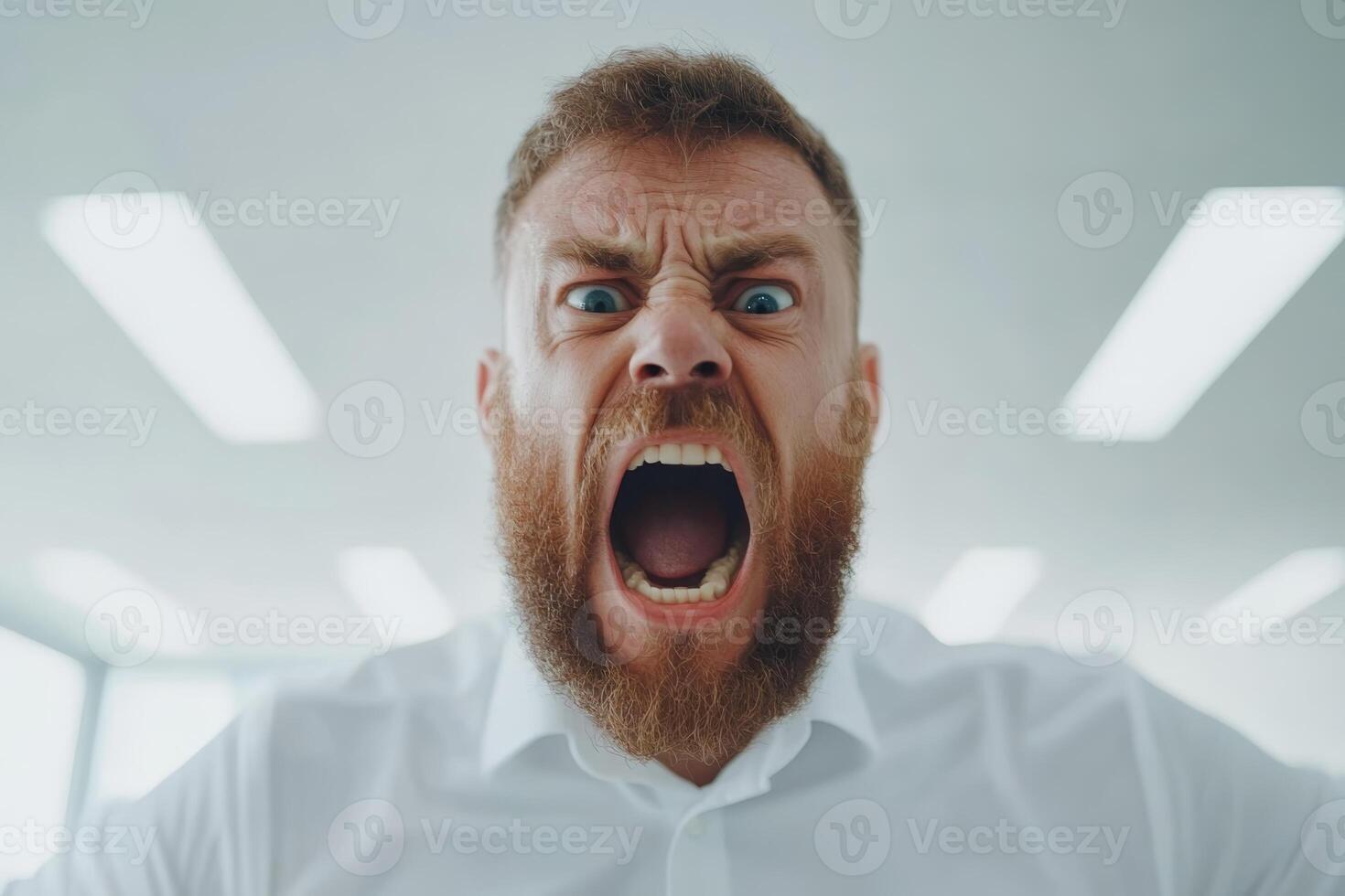 Man expressing intense anger in an office environment during a stressful situation photo