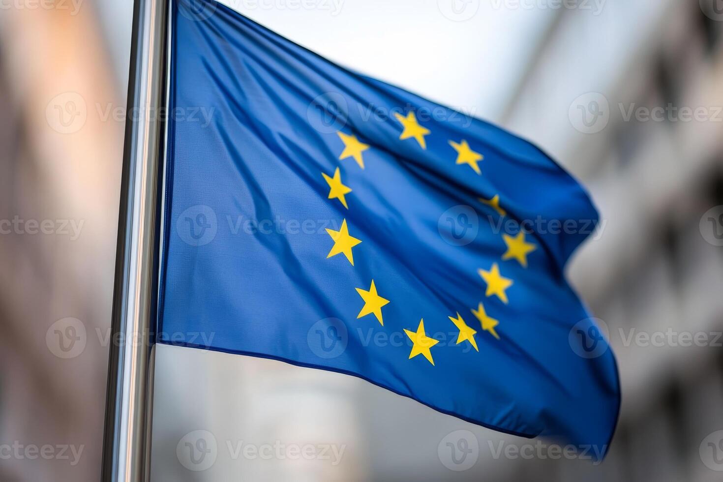 European Union flag waving against a blurred urban backdrop on a sunny day photo