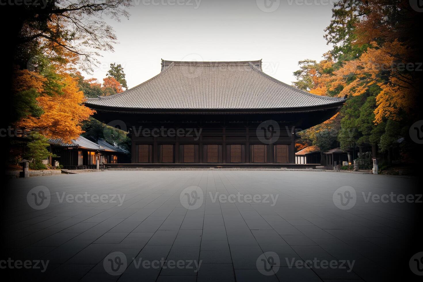 Historic temple surrounded by autumn foliage in a serene garden setting during early morning light photo