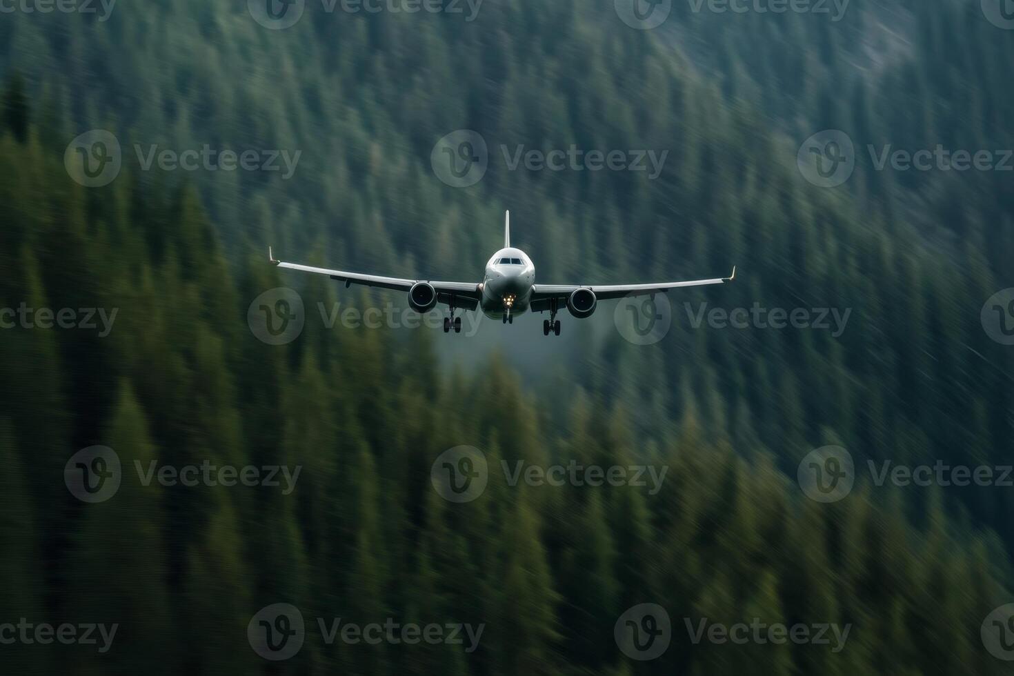 Airplane approaches landing in mountainous region surrounded by dense evergreen forests during daylight photo