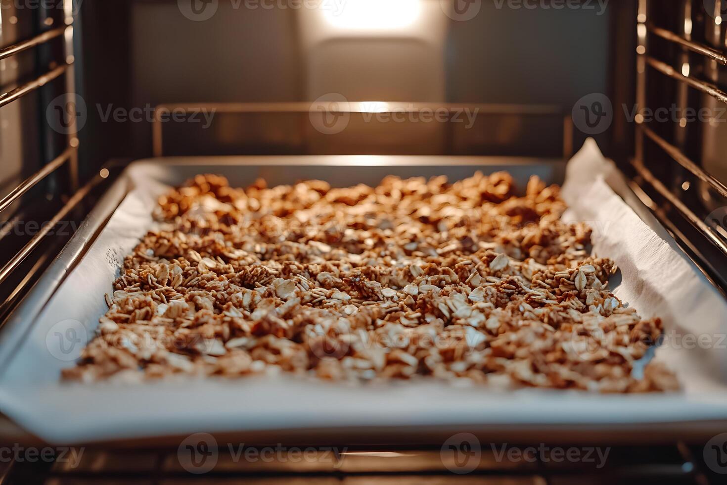 Freshly baked granola on a tray lined with parchment paper, just pulled out of the oven for a warm, golden, and crunchy snack photo