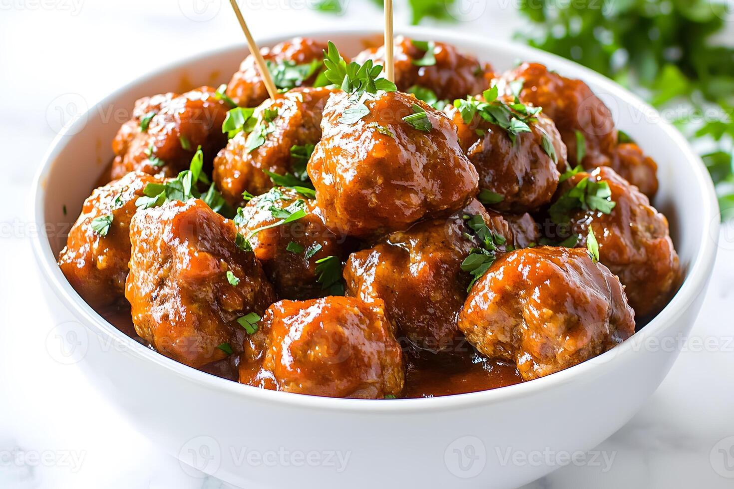 Succulent BBQ meatballs in a tangy sauce, garnished with fresh parsley. Perfect appetizer idea. photo