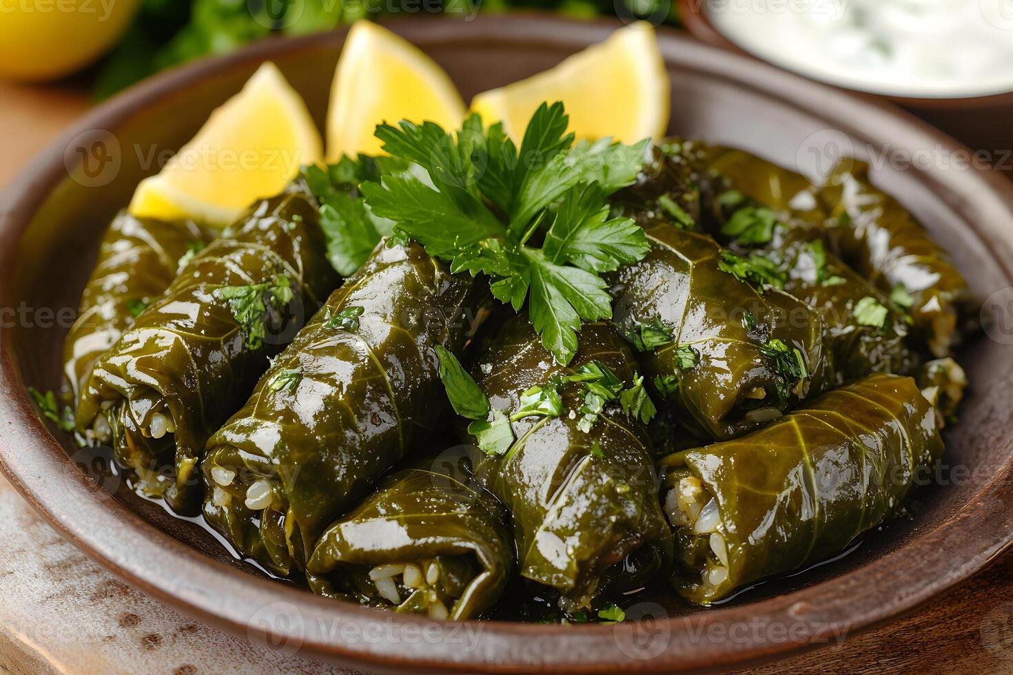 Stuffed grape leaves dolma filled with fragrant rice, herbs, and spices, drizzled with olive oil and garnished with parsley photo
