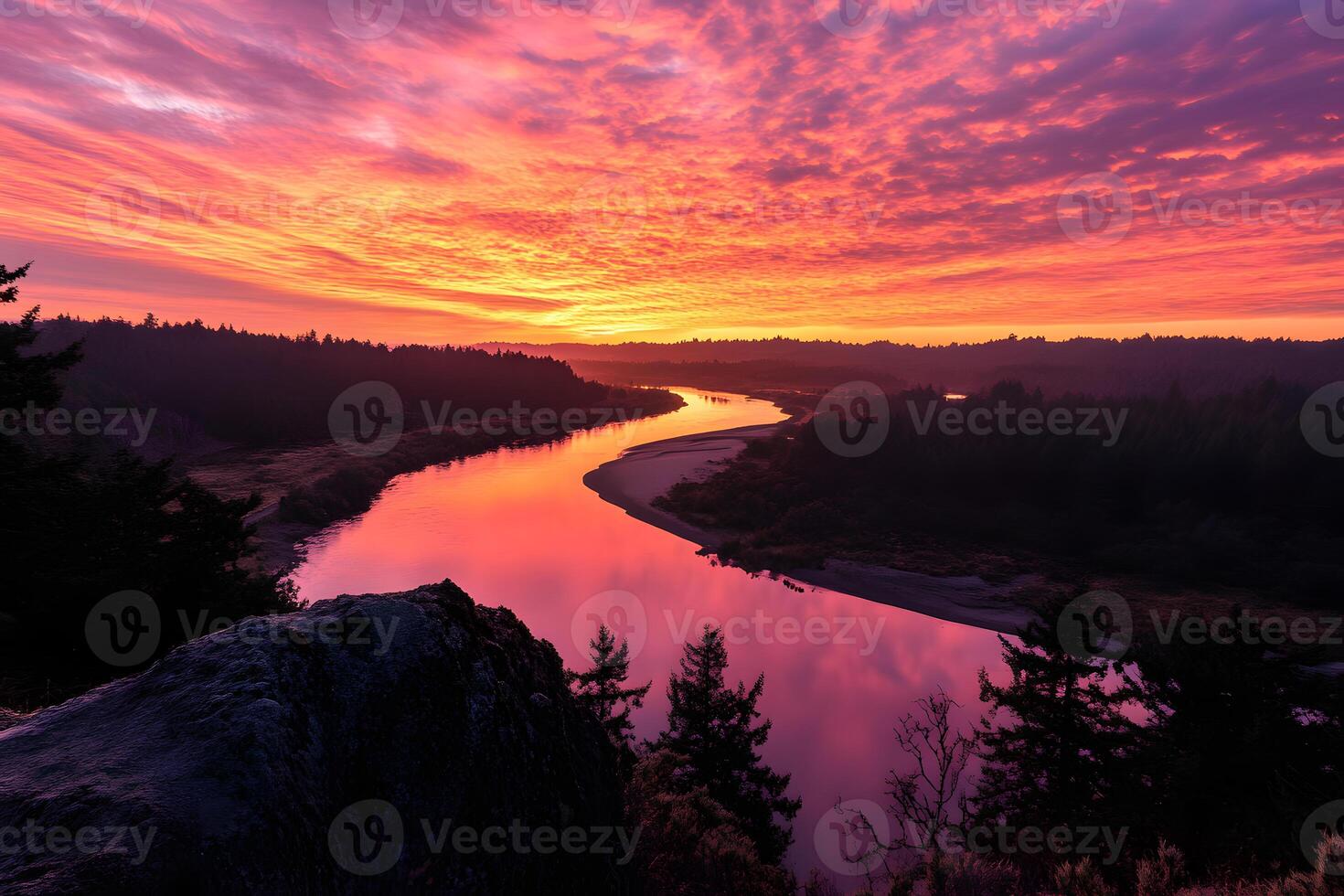 Winding riverbend under a golden sunset, curving around a lush forested area in the evening light photo