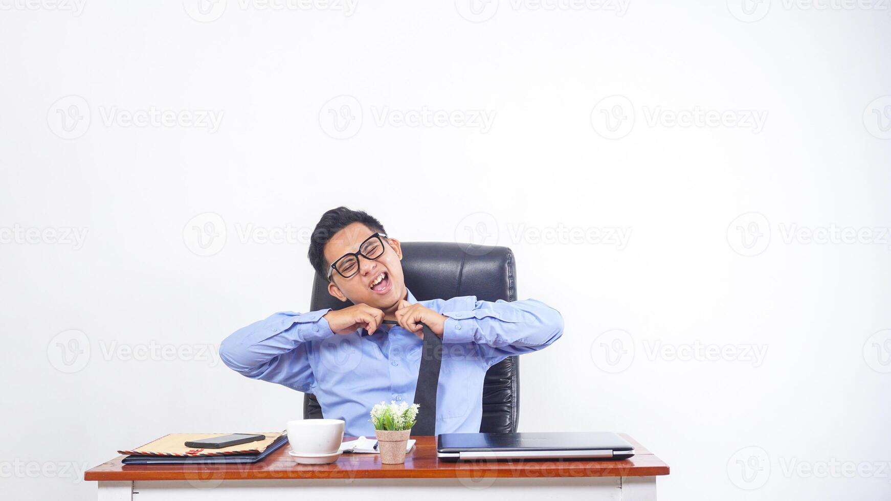 Frustrated and Overworked Asian Office Worker on White Background photo