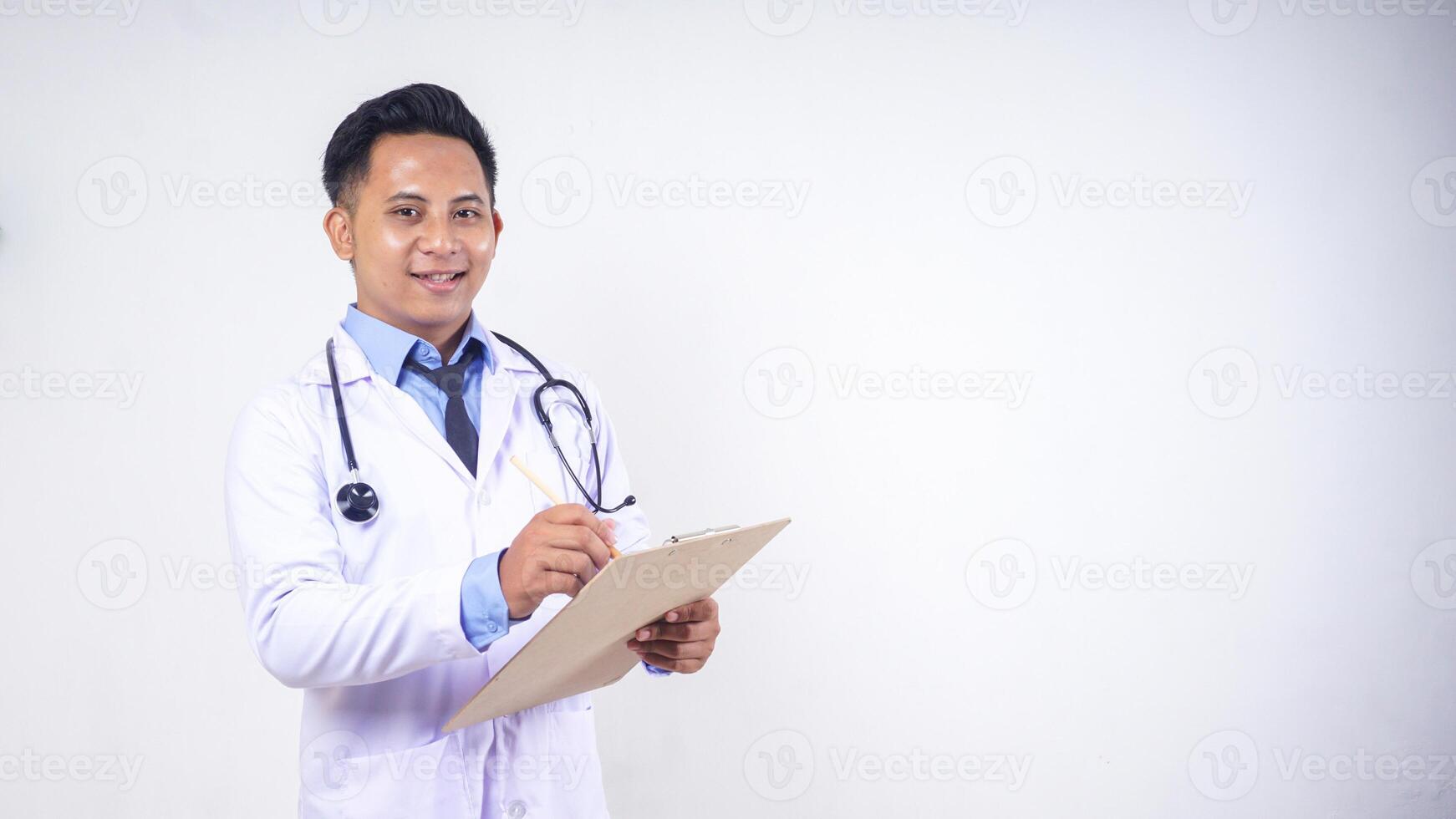 Portrait of Handsome Asian Male Doctor Holding Clipboard with Copy Space on White Background photo