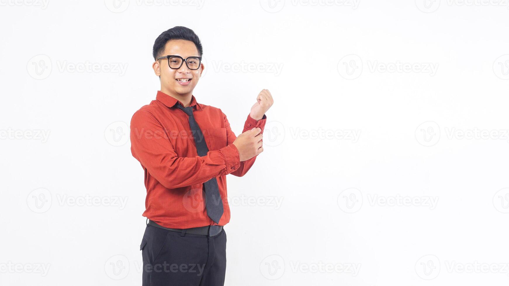 Portrait of Handsome Young Adult Asian Man in Terracotta Colored Shirt Standing on White Background photo