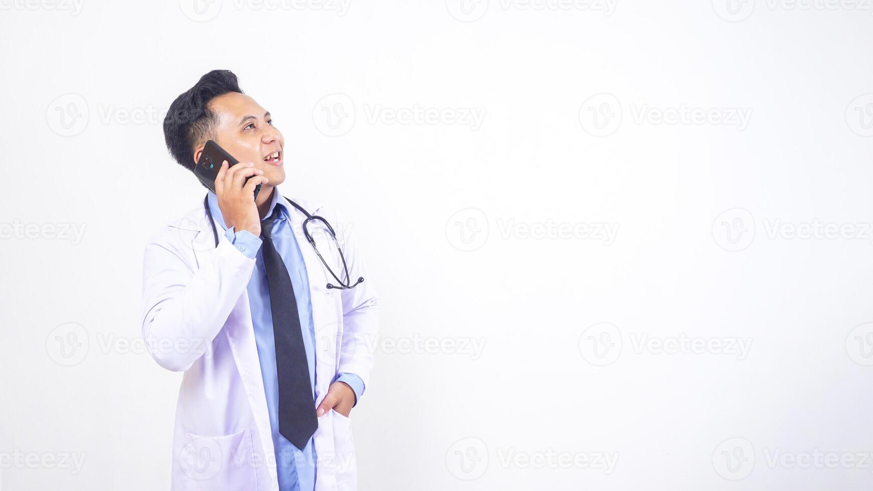 Portrait of Happy Asian Male Doctor Talking on Mobile Phone on White Background photo