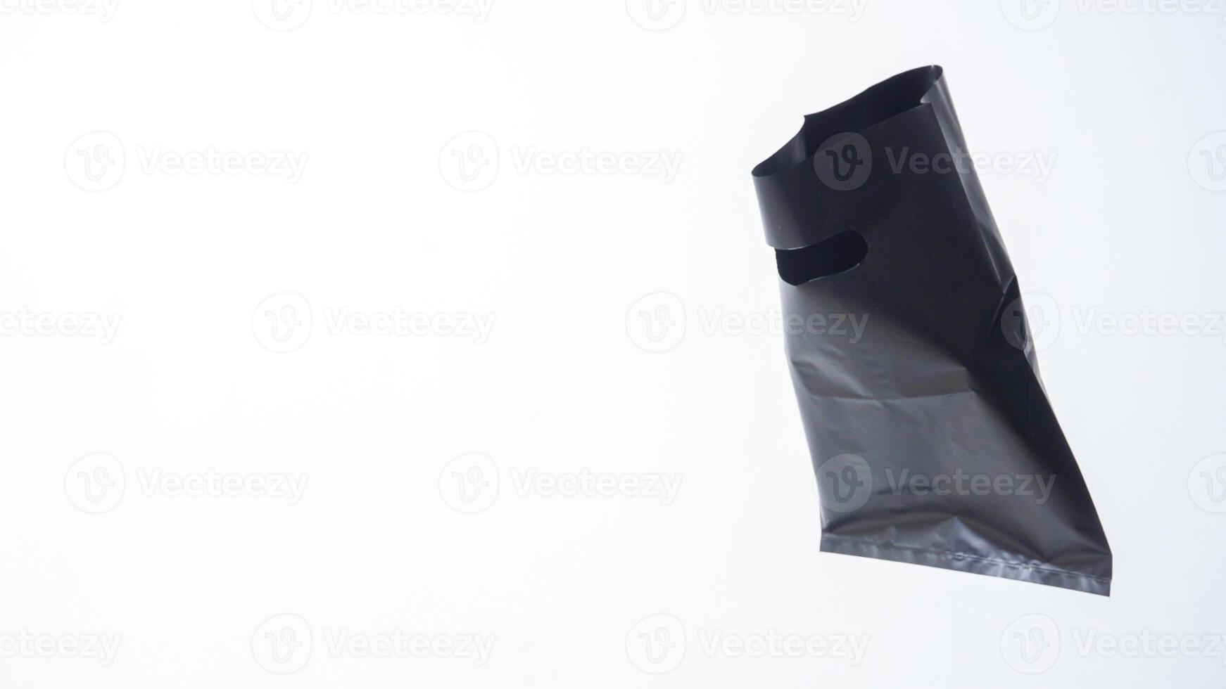 Open Blank Black Plastic Bag on White Background photo